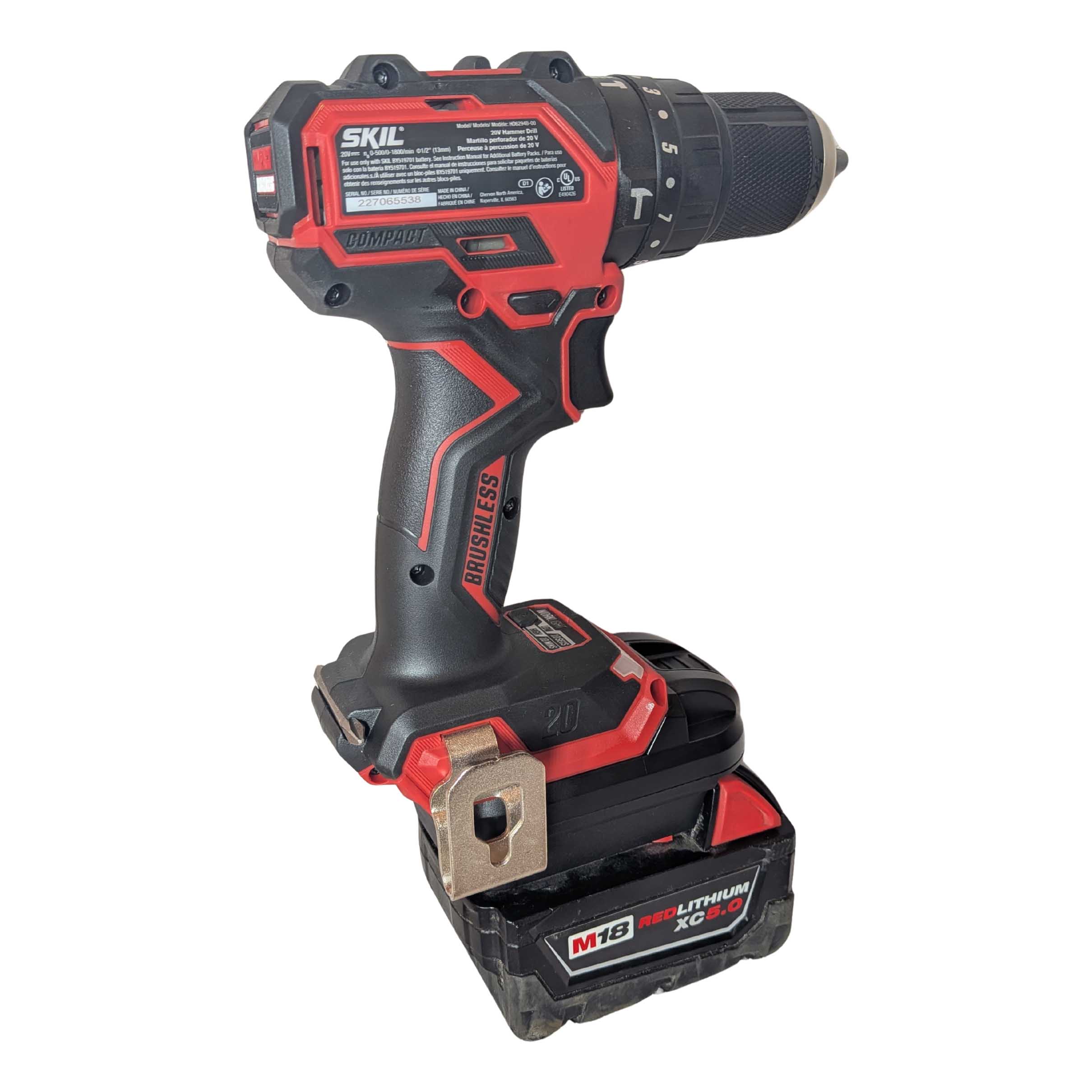 Milwaukee M18 to SKIL 20V PWR CORE battery adapter - rear view installed on a SKIL hammer drill, seated on the battery pack
