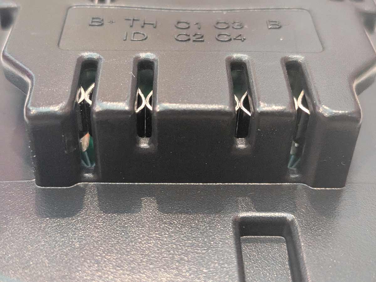 Einhell 18V PXC to DeWalt 20V MAX battery adapter - close-up of the DeWalt tool-side connection, four copper contacts