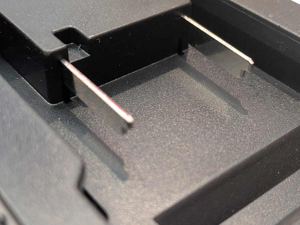 Ozito 18V PXC to Makita 18V LXT battery adapter - close-up of the twin blade terminals on the battery-side connection