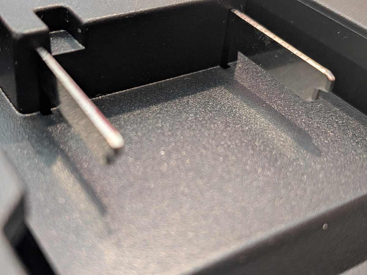Ozito 18V PXC to Milwaukee M18 battery adapter - close-up of the Ozito PXC battery-side connection with twin blade terminals